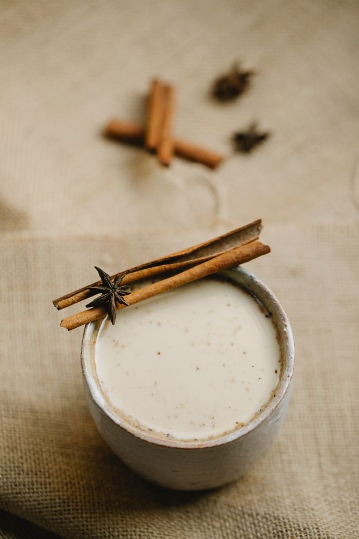 Mastering the First Impression: Your intriguing post title goes here From above cup of spiced traditional milk chai decorated with cinnamon stick and anise stars placed on cloth on blurred background