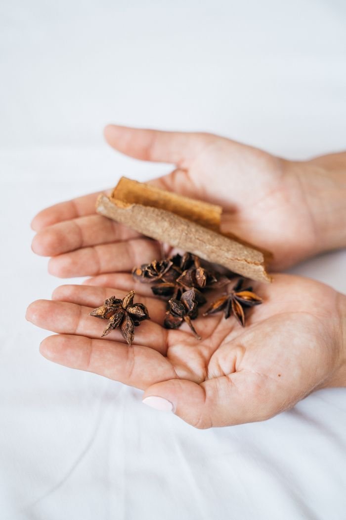 Crafting Captivating Headlines: Your awesome post title goes here Close-up of cinnamon stick and star anise spices held in human hands, perfect for culinary themes.
